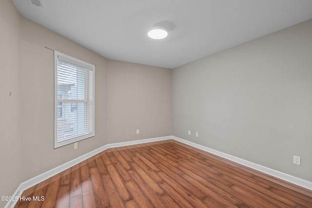 424 Commerce Ave Unit B, Morehead City, NC 28557 - spare room featuring wood finished floors, visible vents, and baseboards