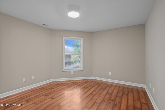 424 Commerce Ave Unit B, Morehead City, NC 28557 - empty room featuring baseboards, visible vents, and wood finished floors