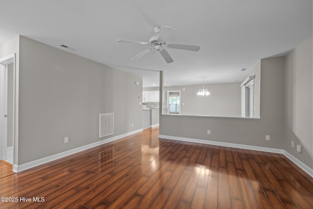 424 Commerce Ave Unit B, Morehead City, NC 28557 - empty room with ceiling fan with notable chandelier, baseboards, hardwood / wood-style flooring, and visible vents
