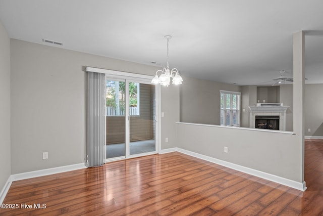 424 Commerce Ave Unit B, Morehead City, NC 28557 - interior space with a fireplace, wood finished floors, visible vents, and a healthy amount of sunlight