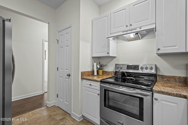 kitchen with white cabinetry, appliances with stainless steel finishes, under cabinet range hood, and baseboards