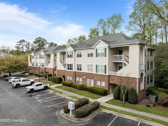 view of property with uncovered parking and a residential view