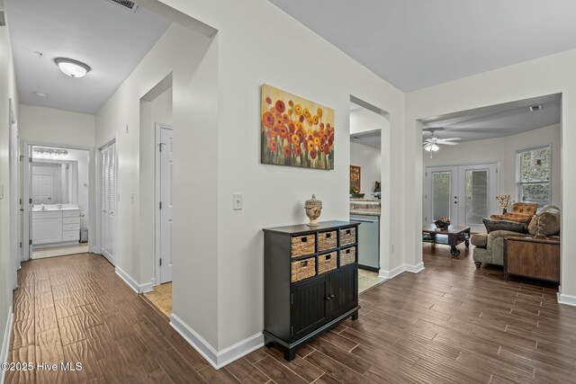 hall with baseboards and wood finish floors