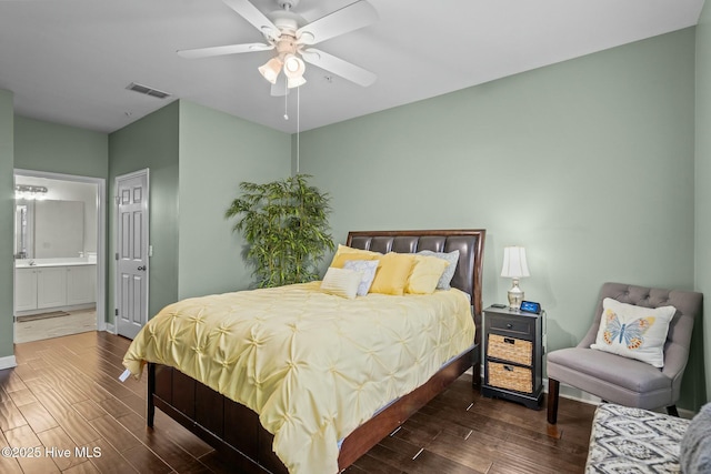 bedroom featuring connected bathroom, visible vents, wood finished floors, and a ceiling fan