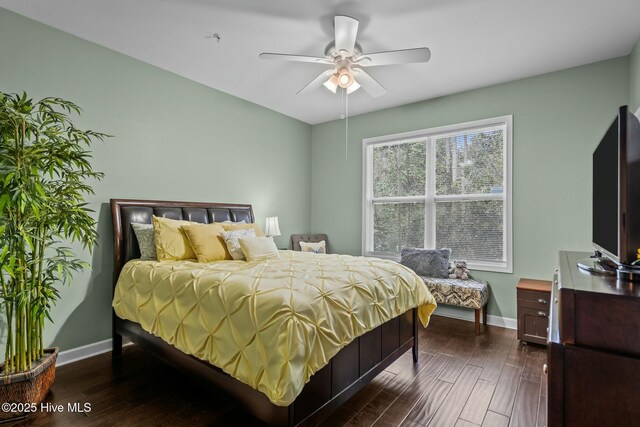 bedroom with baseboards, dark wood-style floors, and ceiling fan