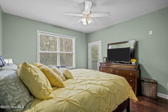 bedroom with a ceiling fan, dark wood-style flooring, and baseboards