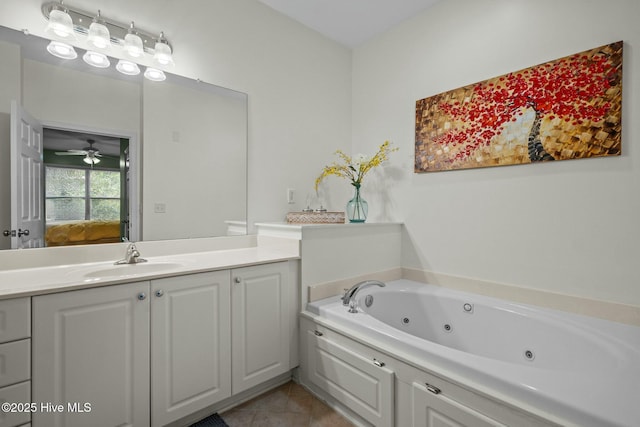 ensuite bathroom with tile patterned floors, vanity, a whirlpool tub, ensuite bath, and ceiling fan