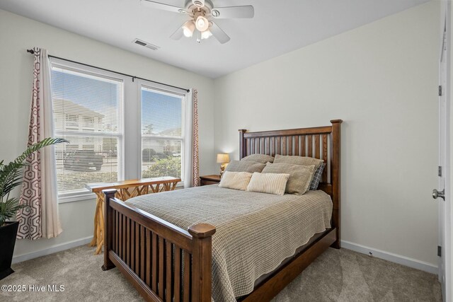 bedroom with light carpet, baseboards, ceiling fan, and visible vents