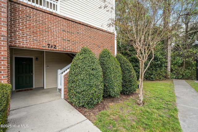 property entrance featuring brick siding