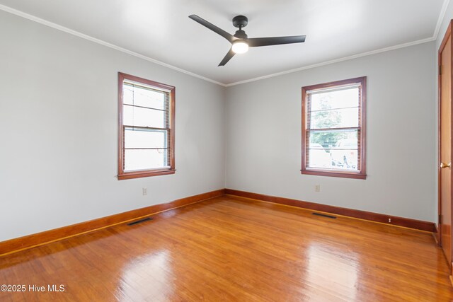 unfurnished room with light wood finished floors, visible vents, ceiling fan, and baseboards