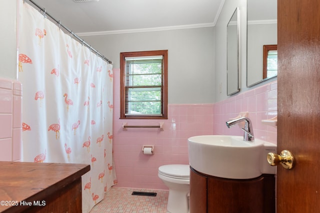 full bathroom featuring tile patterned flooring, tile walls, toilet, vanity, and visible vents