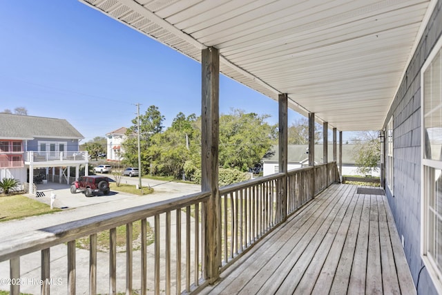100 Moorefield Dr, Carolina Beach, NC 28428 - rear view of house featuring covered porch, fence, metal roof, central AC unit, and a lawn
