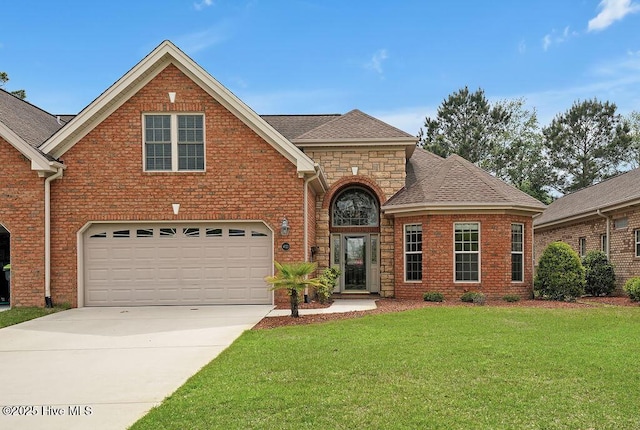 4021 Alastaire Cv, Leland, NC 28451 - traditional home featuring a shingled roof, a front lawn, an attached garage, driveway, and brick siding