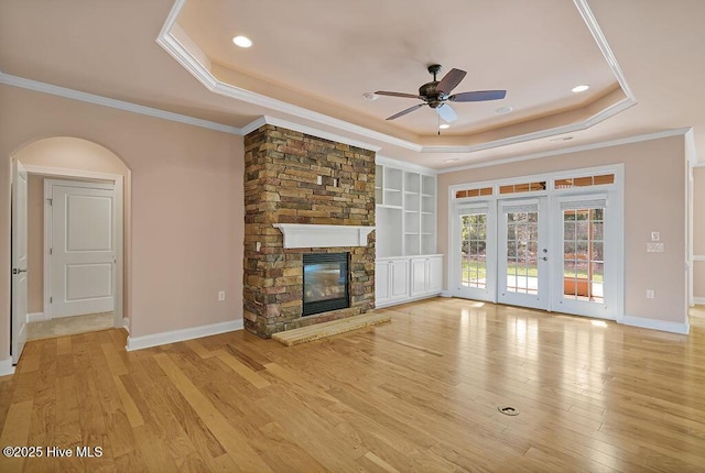 4021 Alastaire Cv, Leland, NC 28451 - unfurnished living room with light wood-type flooring, ceiling fan, a fireplace, a raised ceiling, and recessed lighting