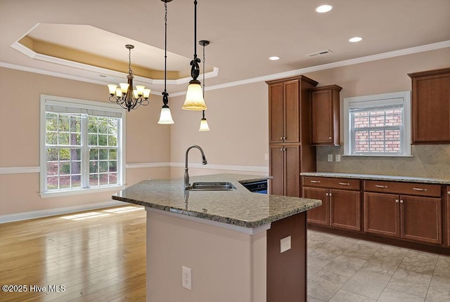4021 Alastaire Cv, Leland, NC 28451 - kitchen featuring recessed lighting, an island with sink, a sink, a chandelier, and hanging light fixtures