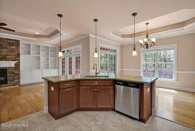 4021 Alastaire Cv, Leland, NC 28451 - kitchen featuring stainless steel dishwasher, a sink, a raised ceiling, stone countertops, and ornamental molding