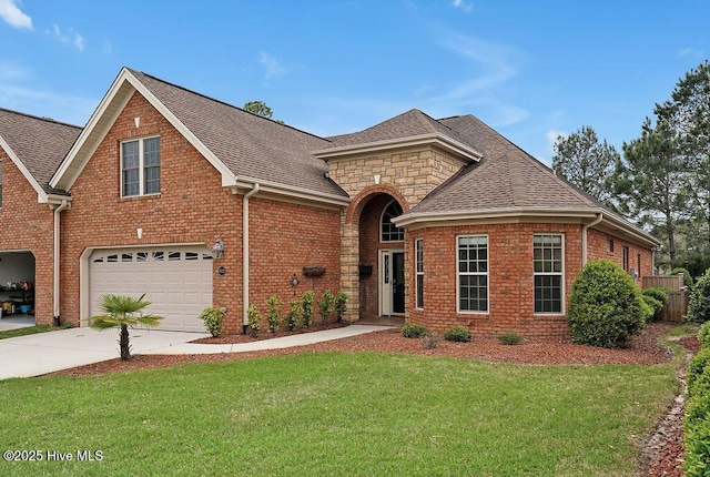 4021 Alastaire Cv, Leland, NC 28451 - view of front of house with driveway, brick siding, a front yard, and a garage