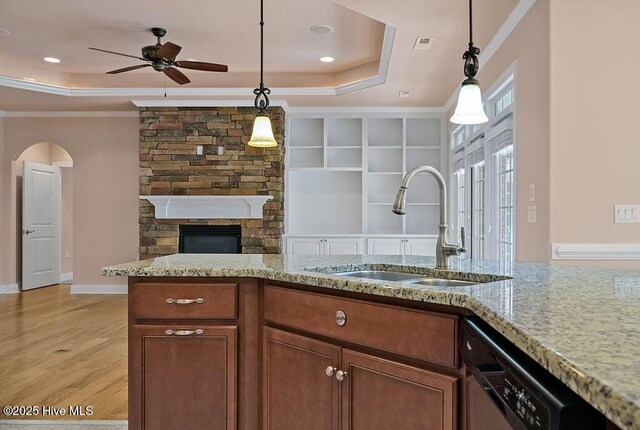 4021 Alastaire Cv, Leland, NC 28451 - kitchen featuring dishwasher, a tray ceiling, a stone fireplace, and a ceiling fan