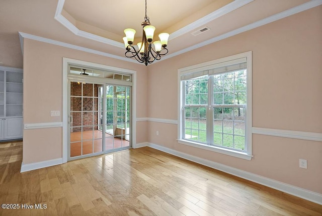 4021 Alastaire Cv, Leland, NC 28451 - empty room featuring baseboards, visible vents, a chandelier, wood finished floors, and crown molding