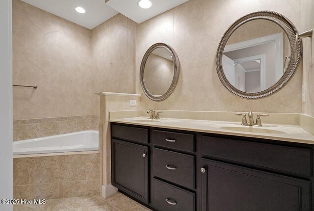 4021 Alastaire Cv, Leland, NC 28451 - bathroom with tile patterned flooring, tiled bath, a sink, and double vanity