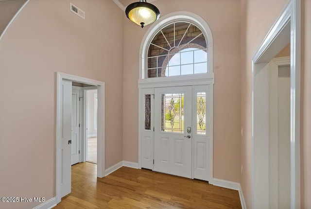 4021 Alastaire Cv, Leland, NC 28451 - foyer with light wood-style floors, visible vents, baseboards, and a high ceiling