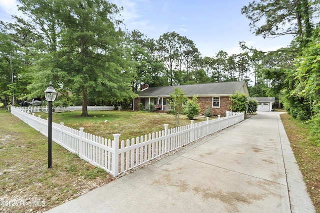211 E 11th St, Southport, NC 28461 - single story home with a chimney, a garage, brick siding, and view of wooded area