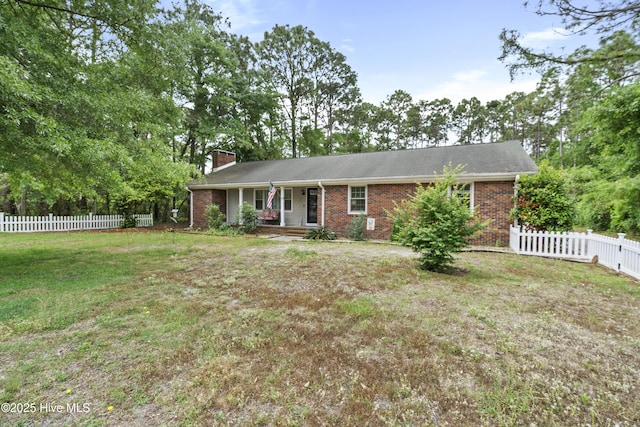 211 E 11th St, Southport, NC 28461 - view of front of property featuring a porch, brick siding, and a chimney