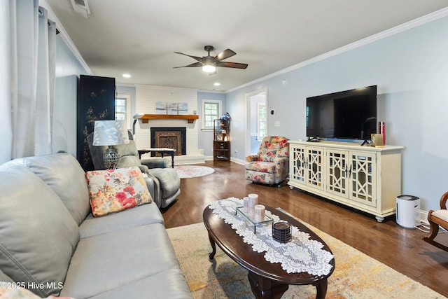 211 E 11th St, Southport, NC 28461 - living room featuring crown molding, wood finished floors, a ceiling fan, a fireplace, and recessed lighting