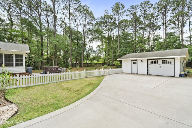 211 E 11th St, Southport, NC 28461 - view of yard featuring a hot tub, an outbuilding, a garage, and view of wooded area
