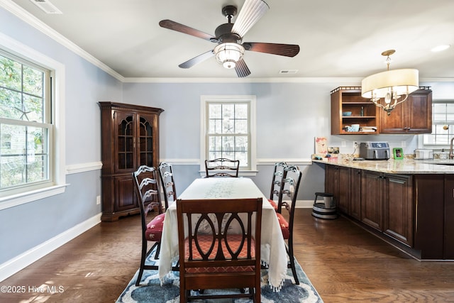 211 E 11th St, Southport, NC 28461 - dining room with plenty of natural light, dark wood-style floors, and crown molding