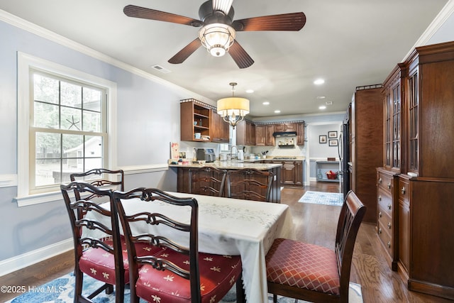 211 E 11th St, Southport, NC 28461 - dining area with dark wood-type flooring, ornamental molding, baseboards, recessed lighting, and a ceiling fan