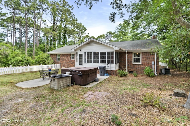211 E 11th St, Southport, NC 28461 - rear view of property featuring a hot tub, a patio, brick siding, central AC, and a shingled roof