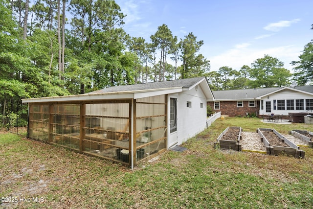 211 E 11th St, Southport, NC 28461 - rear view of house featuring a garden