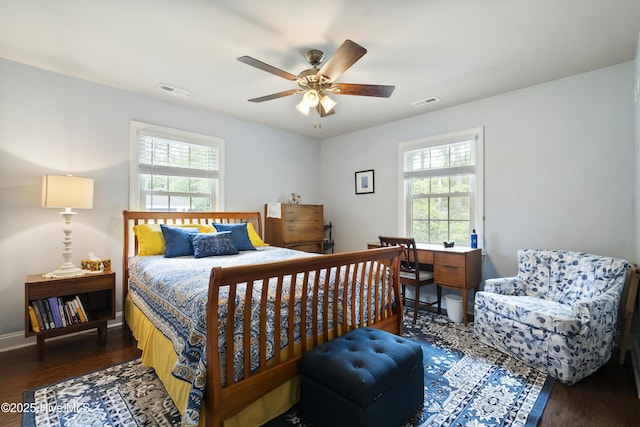 211 E 11th St, Southport, NC 28461 - bedroom featuring multiple windows, wood finished floors, a ceiling fan, and baseboards