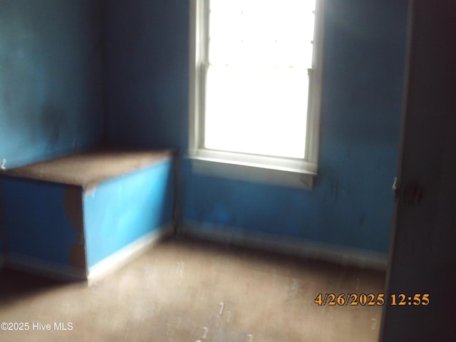 spare room featuring baseboards