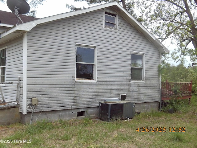 view of property exterior featuring a deck, crawl space, and central AC