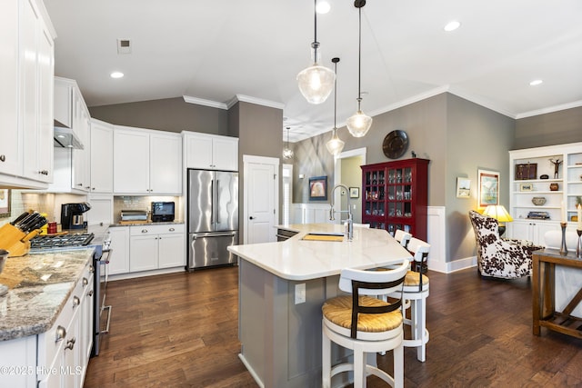 1443 Ellsworth Dr SW, Ocean Isle Beach, NC 28469 - kitchen featuring high quality appliances, a sink, backsplash, lofted ceiling, and dark wood-style floors