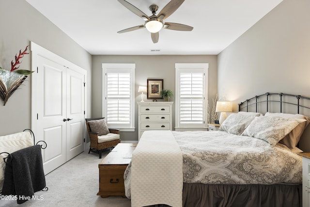 1443 Ellsworth Dr SW, Ocean Isle Beach, NC 28469 - bedroom with light colored carpet, a closet, and ceiling fan