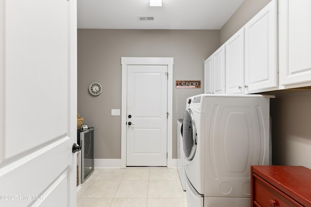 1443 Ellsworth Dr SW, Ocean Isle Beach, NC 28469 - laundry room with washer / clothes dryer, light tile patterned flooring, cabinet space, and baseboards