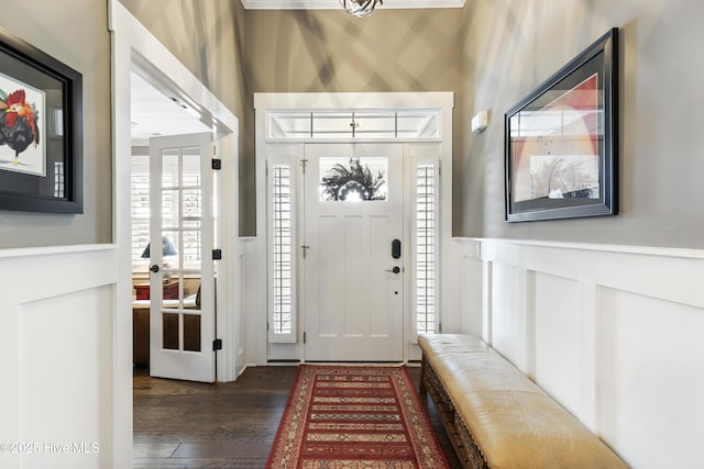1443 Ellsworth Dr SW, Ocean Isle Beach, NC 28469 - foyer featuring wainscoting, dark wood-type flooring, and a decorative wall