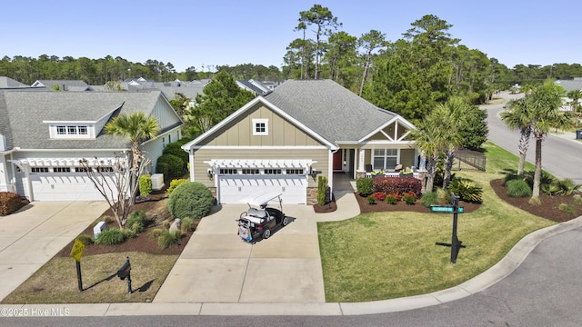 1443 Ellsworth Dr SW, Ocean Isle Beach, NC 28469 - view of front of property with board and batten siding, concrete driveway, a front yard, and a porch