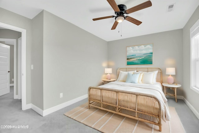 carpeted bedroom featuring visible vents, a ceiling fan, and baseboards