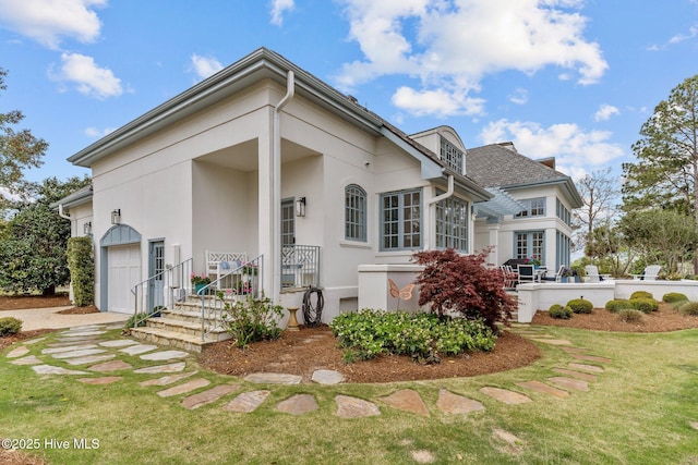 605 Dundee Dr, Wilmington, NC 28405 - view of front of property with stucco siding, a garage, and a front yard