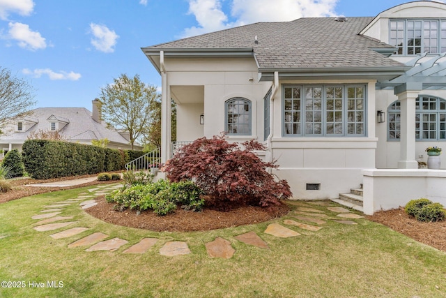 605 Dundee Dr, Wilmington, NC 28405 - view of front of home with a shingled roof, a front lawn, and stucco siding