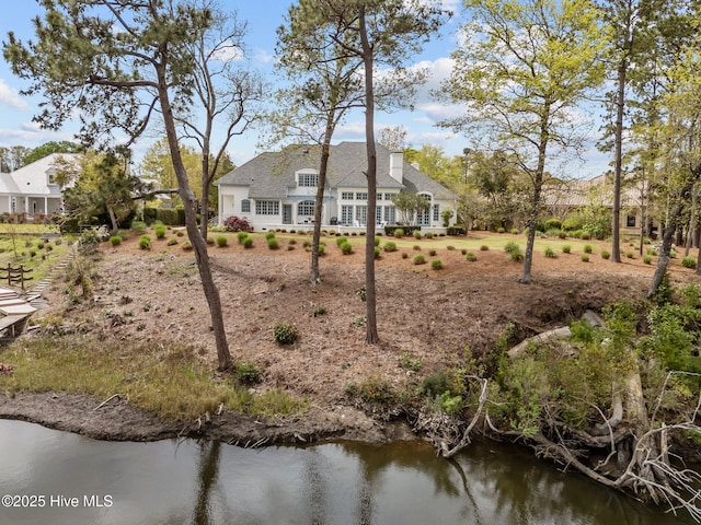 605 Dundee Dr, Wilmington, NC 28405 - rear view of house with a water view and roof with shingles
