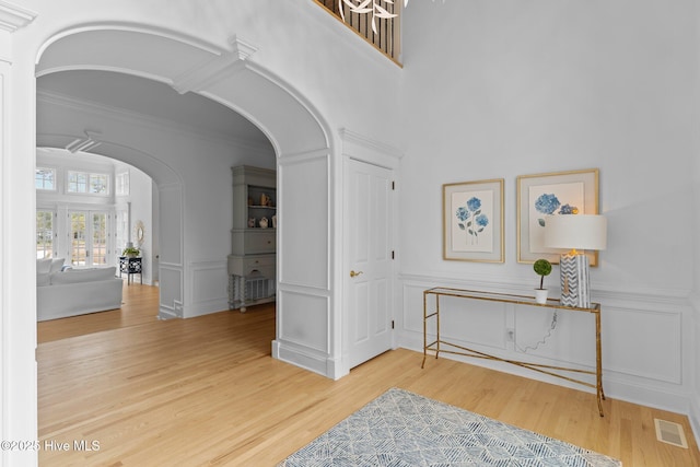 605 Dundee Dr, Wilmington, NC 28405 - entryway featuring arched walkways, a decorative wall, wood finished floors, and ornamental molding