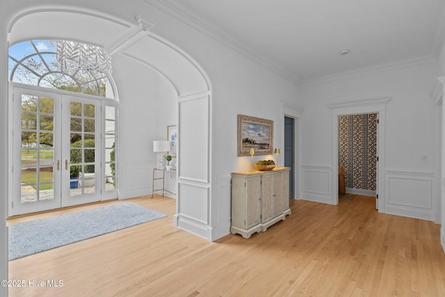 605 Dundee Dr, Wilmington, NC 28405 - foyer entrance with a decorative wall, light wood finished floors, french doors, and ornamental molding