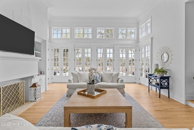 605 Dundee Dr, Wilmington, NC 28405 - living room with a towering ceiling, plenty of natural light, french doors, light wood-style flooring, and crown molding