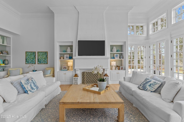 605 Dundee Dr, Wilmington, NC 28405 - living room with ornamental molding, built in shelves, wood finished floors, and a towering ceiling