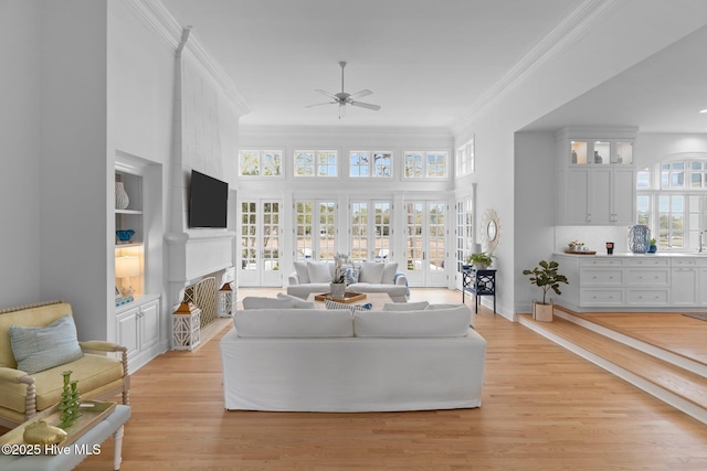 605 Dundee Dr, Wilmington, NC 28405 - living room with a ceiling fan, ornamental molding, a fireplace, and light wood-style floors
